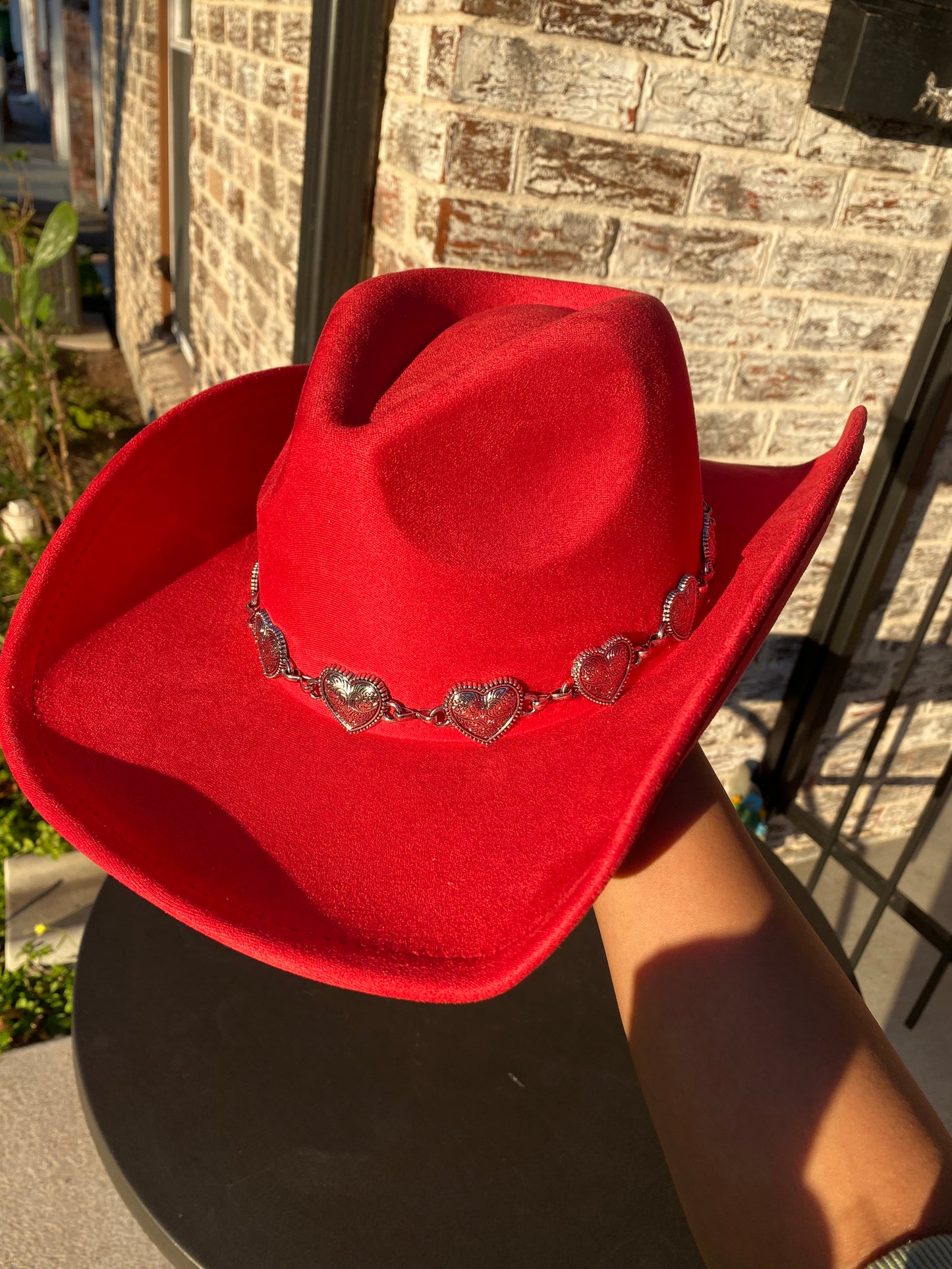 Red cowgirl hat with metallic hearts